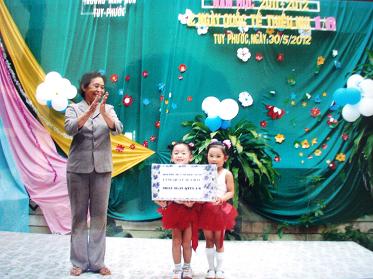 Đại diện Hội Phụ huynh học sinh tặng quà cho các cháu Trường Mầm non huyện nhân ngày Quốc tế thiếu nhi 1.6
